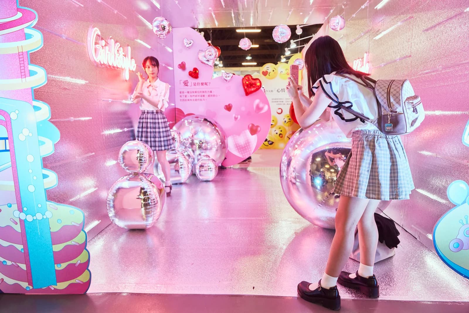2024 女生日常節，女生在粉色鏡面裝置裡跟朋友拍照